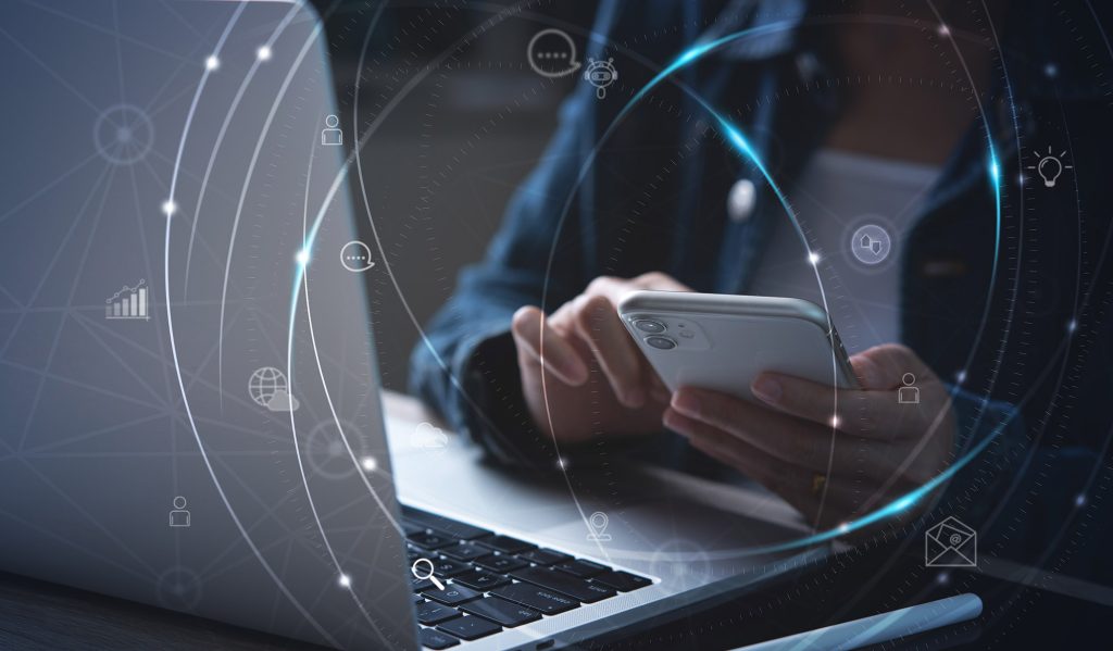 Person using a laptop with a digital network overlay