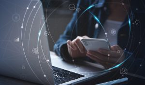Person using a laptop with a digital network overlay