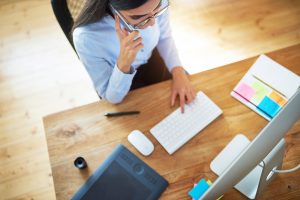 Businesswoman taking a call on her mobile phone at her desk